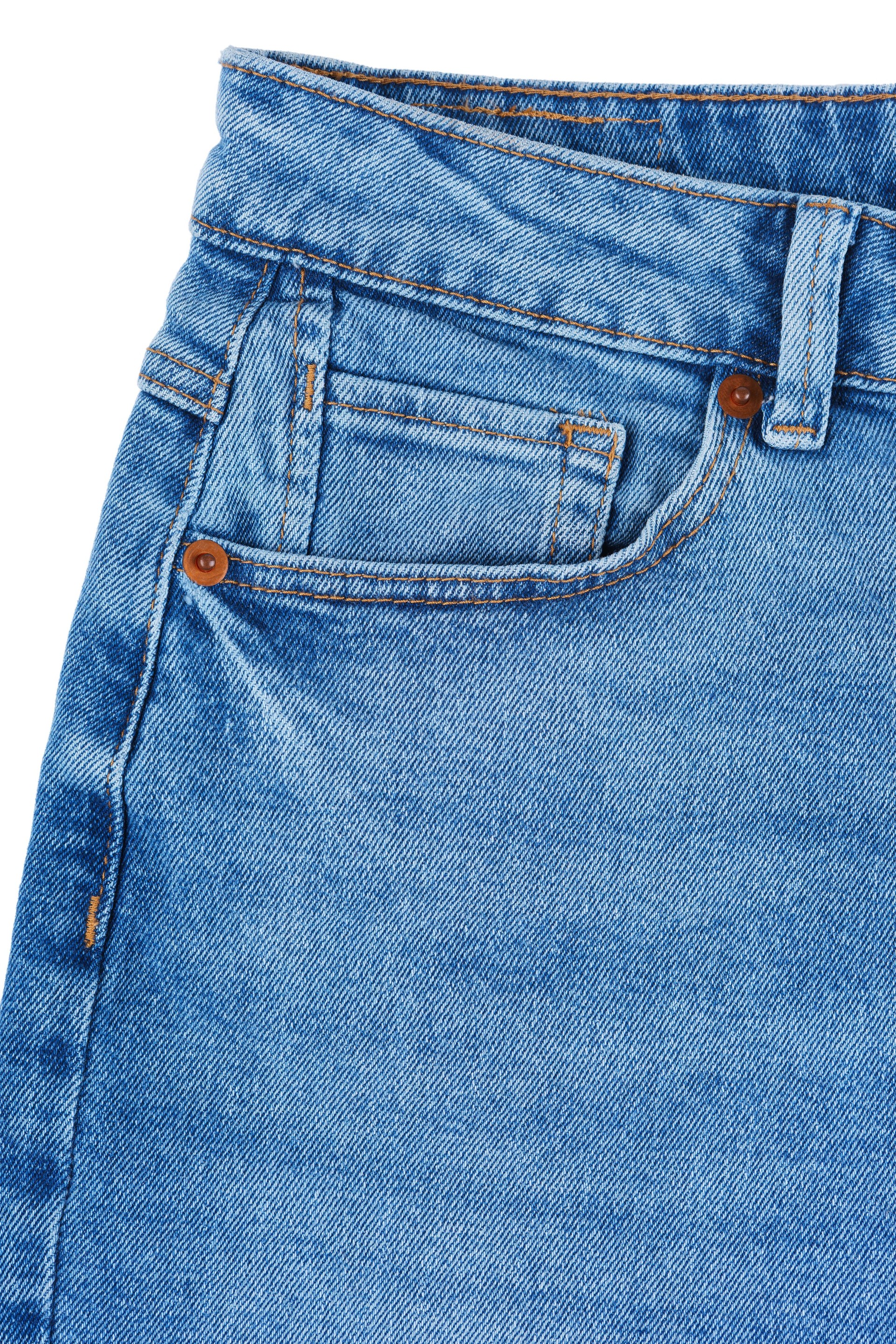 Front side of blue jeans pants. Design details, waistband, pocket, small pocket and decorative seams